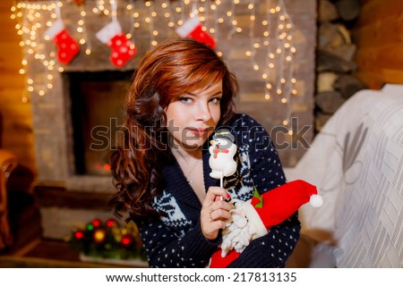beautiful woman near the fireplace in the winter house.  christmas, family holidays