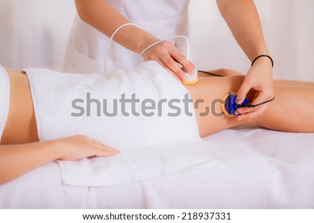 beautician conducts cosmetic procedures for body, beauty treatment for the skin thighs in a beauty salon