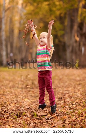 Beautiful girl jumping in autumn park. active, to rest, to run