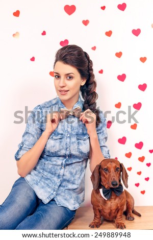 happy girl with a dog dachshund against the background of the heart. close-up, International Women\'s Day, Valentine\'s Day, March 8, Mother\'s Day