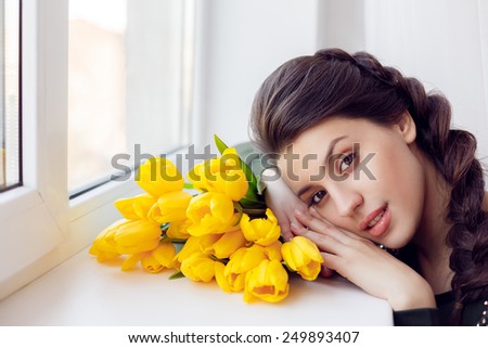 happy girl at the window with tulips. close-up, International Women\'s Day, Valentine\'s Day, March 8, Mother\'s Day