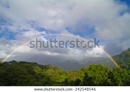 Tropical rainbow. Days with mixed blue skies, clouds, rain or drizzle, sun, and rainbows are common in Boquete, Panama.