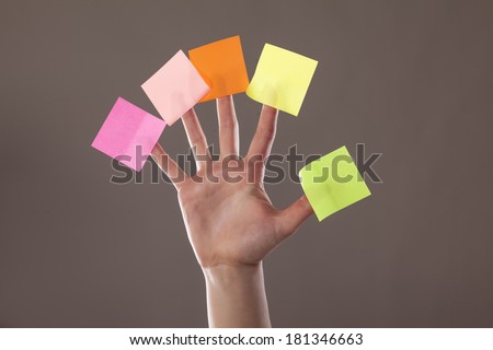 female hand with five paper stickers on her fingers