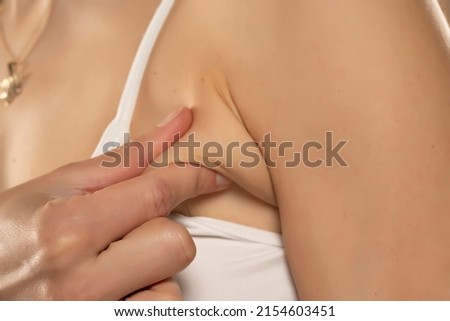 Armpit fat at woman between 30-40 years old dressed in a sporty bra. closeup photo. Photo stock © 