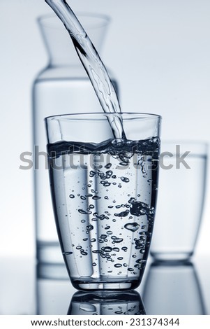 glass fill with water and a carafe in the background