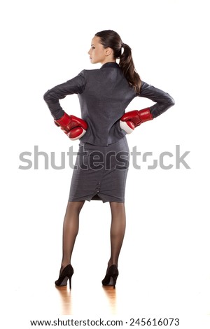 Back view of business woman with boxing gloves on a white