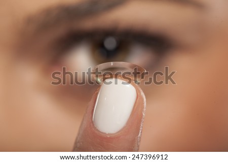Close up of a girl inserting contact lens