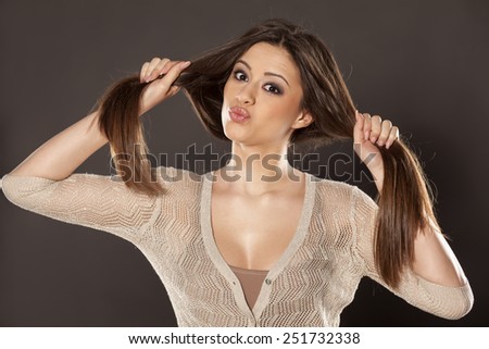funny young woman holding her hair in tails
