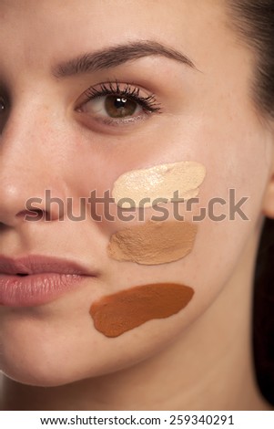 Face of woman with tree different tones of liquid foundation