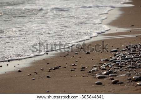 seacoast with fine sand and small round stones
