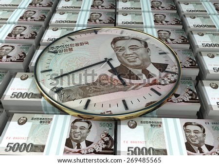 3D clock on piles and stack of North Korea money