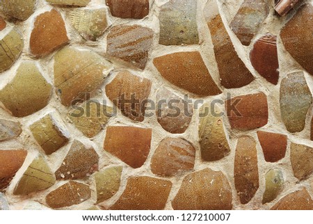 Many broken pottery in cement wall background.