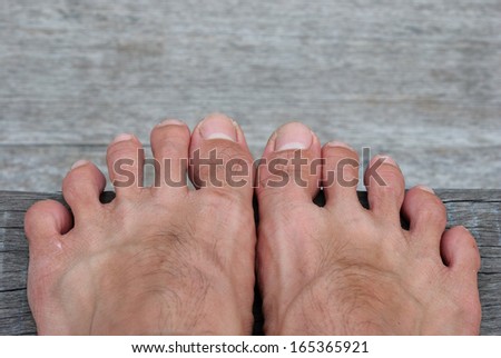 A couple of feet on old wood background