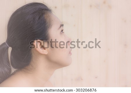 woman portrait with blur wood wall background