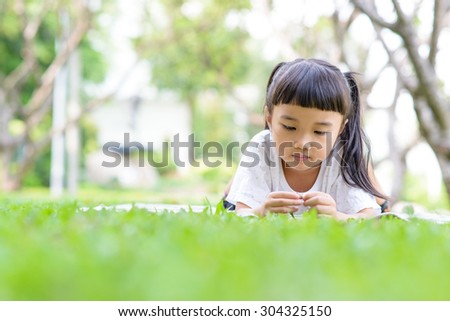Thai kid thinking and play in the garden