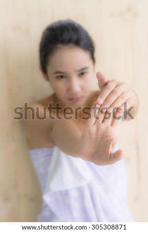 Woman portrait massage hand pose with blur wood background