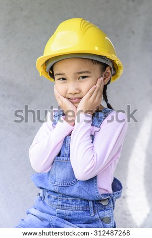 Little civil engineer girl portrait in huge concrete pipe