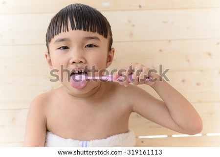 Little Asian girl take a bath; Brush teeth and tongue