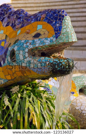 Ceramic dragon fountain in Parc Guell - park city designed by Antoni Gaudi. Spain