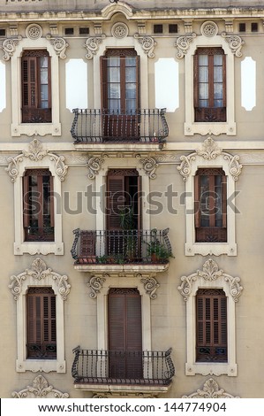 facade house with old window, balcony, jalousie in Barcelona