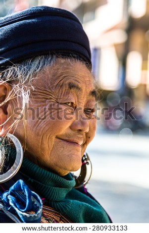 Sapa, Lao Cai Province, Vietnam - November 25, 2014: Hmong old woman at a market and wearing traditional attire in Sapa town on November 25, 2014, Lao Cai Province, North Vietnam.