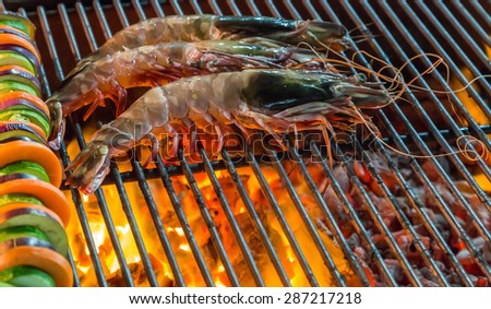 seafood grilled shrimp by fire and BBQ Flames. Restaurant Barbecue at the night market