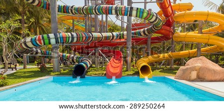 Aquapark sliders, water slike on outdoor swimming pool, water park.