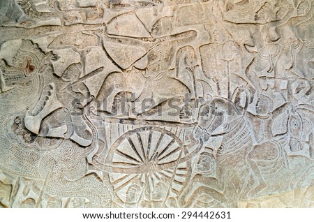 Khmer relief carving of gods fighting demons. Inner wall of the temple of Angkor Wat, Siem Reap, Cambodia.