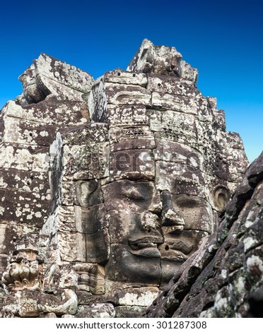 stone faces of king Bayon Temple Angkor Thom, Cambodia. Ancient monument Khmer architecture.