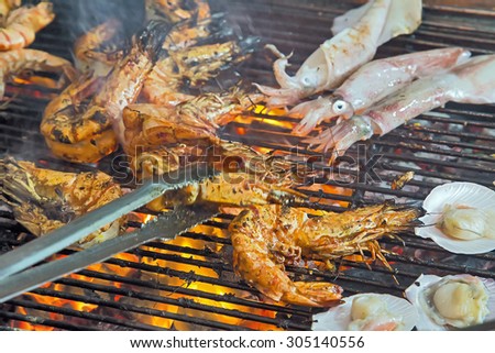 Shrimp grilled seafood by fire and BBQ Flames. Restaurant Barbecue at the night market