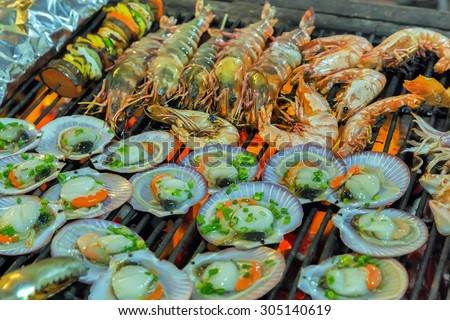 Grilling sea food on the flaming grill. Summer barbecue concept seafood.