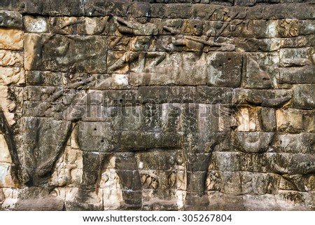 elephant Khmer relief carving of gods fighting demons. Inner wall of the temple of Angkor Wat, Siem Reap, Cambodia.