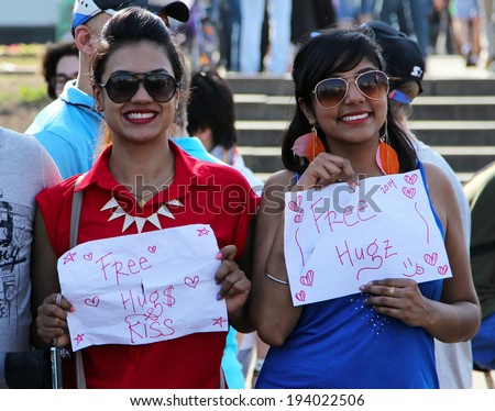 MOSCOW, RUSSIA - MAY 18, 2014: Two smiling beautiful girls offering Free Hugs at Cosplay festival at the All-Russian Exhibition Center in Moscow