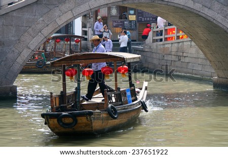 ZHUJIAJIAO, CHINA - OCT 29, 2009: Tourist boat on canal of ancient water town - Chinese Venice near Shanghai, with a history of more than 1700 years