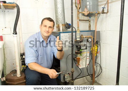 Plumber fixing gas furnace