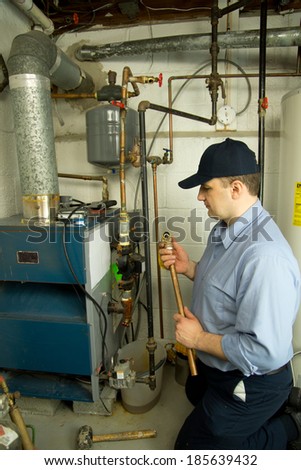 Plumber repairs gas furnace