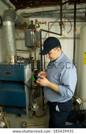 Plumber repairs gas furnace