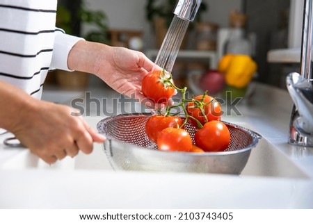 Woman washing vegetables on kitchen counter. Healthy foods Stock foto © 