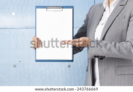 Businesswoman holding blank clipboard