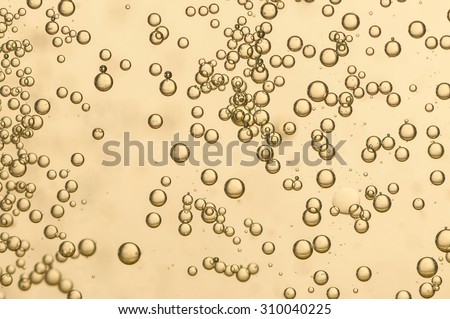 many champagne bubbles flowing toward the surface