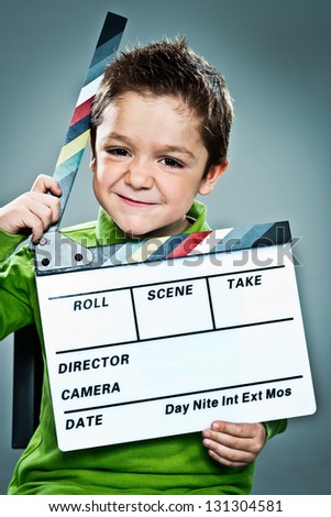 Little Actor with a Slate in His Head over a Grey Background