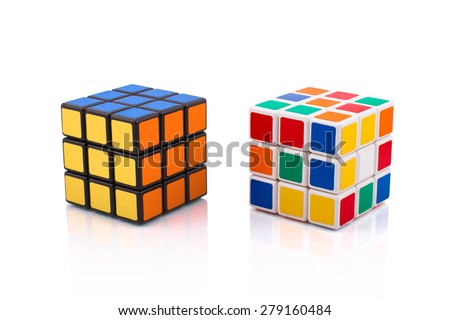 KRAGUJEVAC, SERBIA - APRIL 9, 2015: Two Rubik\'s cubes on a white background. Rubik\'s Cube invented by a Hungarian architect Erno Rubik in 1974.