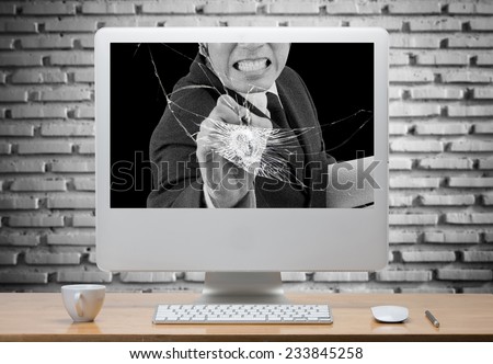 Angry businessman destroyed Computer screen on desk,clipping path