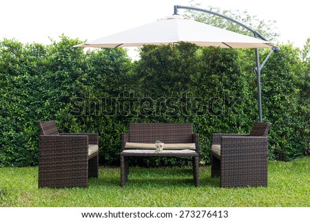 Set of rattan garden furniture under a big garden umbrella,clipping path