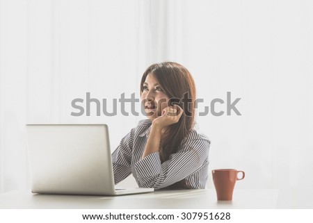 Beautiful young asian woman using laptop, Noise and film grain style.