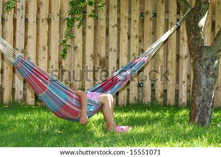 Little girl having a rest in a hammock