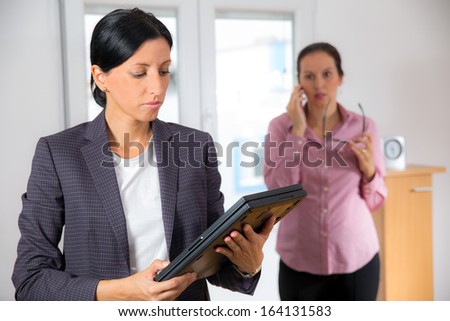 Two business women team at office building