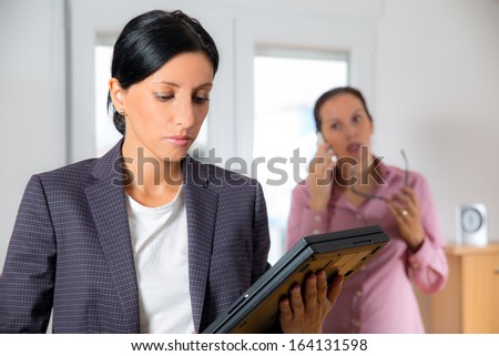 Two business women team at office building