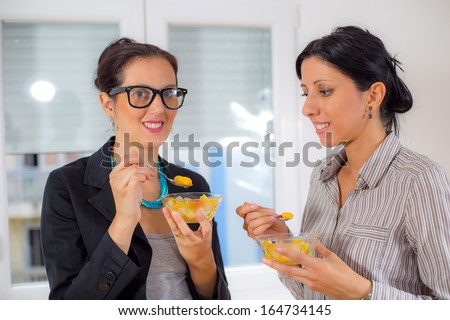 business women eating fruits salad