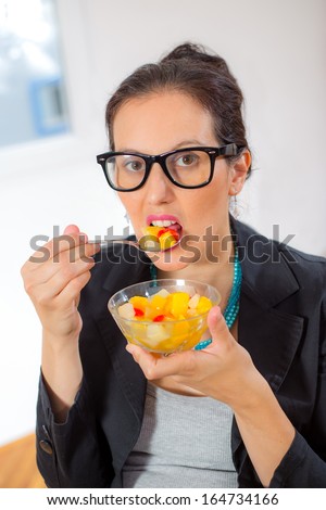 business woman eating fruits salad